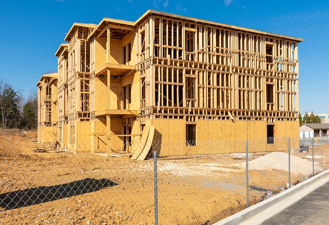 a temporary chain link fence in front of a building under construction, ensuring public safety in Cordova, TN